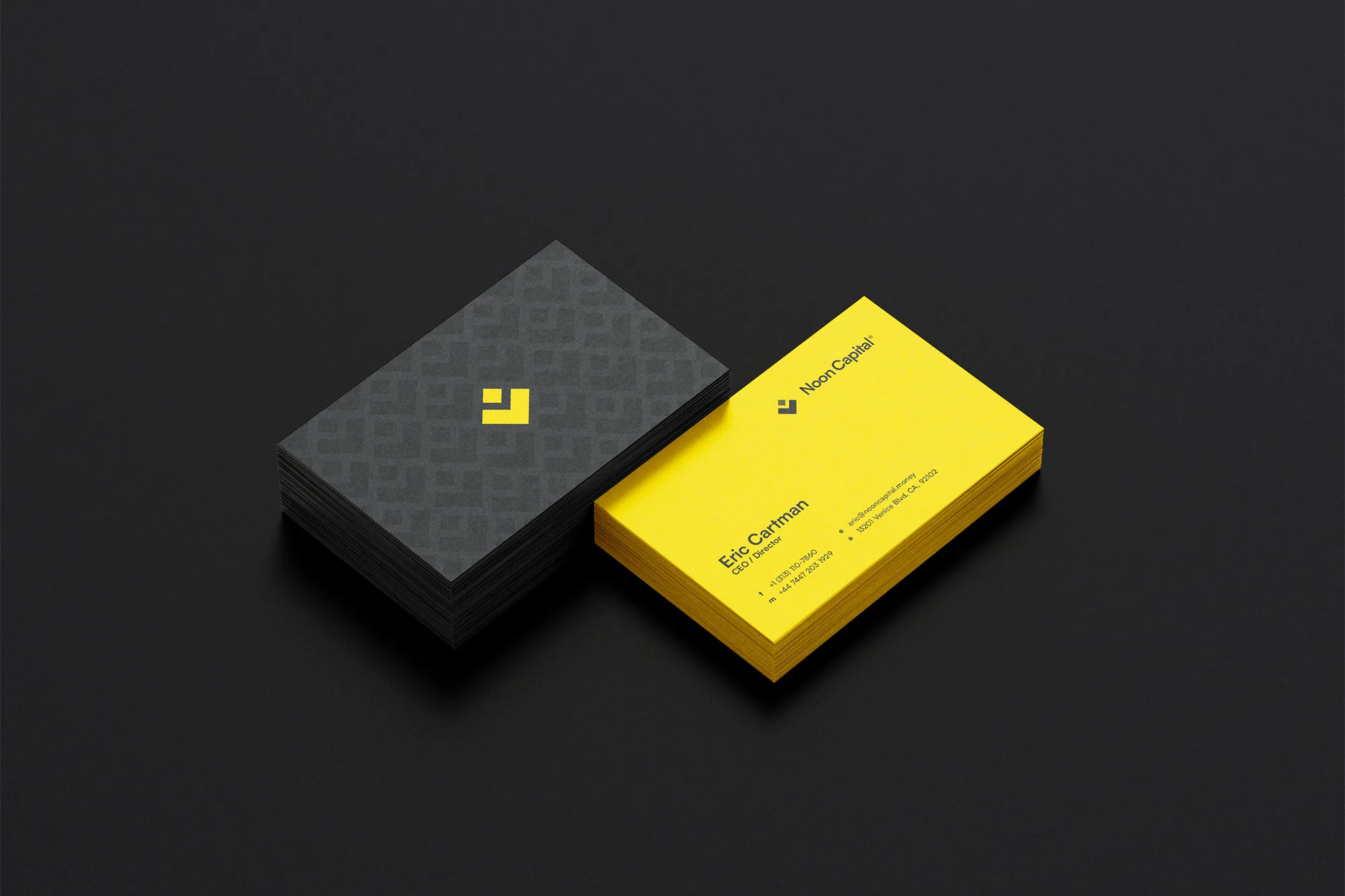 Noon Capital — business cards, one charcoal with the brand pattern and one yellow
