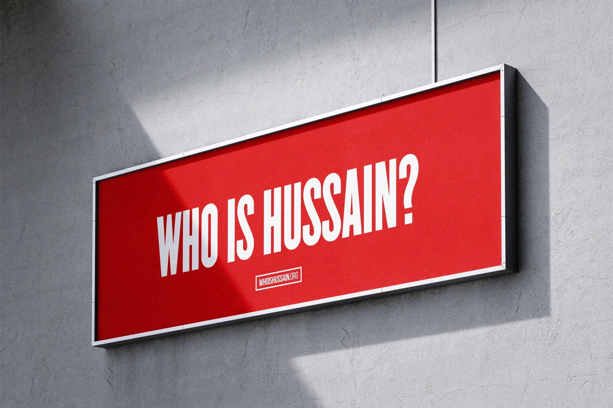 Who is Hussain — a red “WHO IS HUSSAIN?” panel mounted on a wall